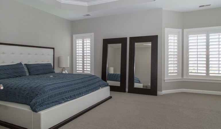 Polywood shutters in a minimalist bedroom in Austin.